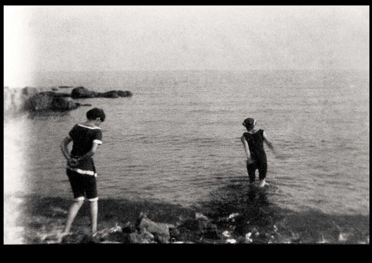 Photographs by Mary Stella Edwards of two women in bathing suits walking into the sea