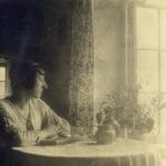 Judith Ackland sitting at the table in The Cabin